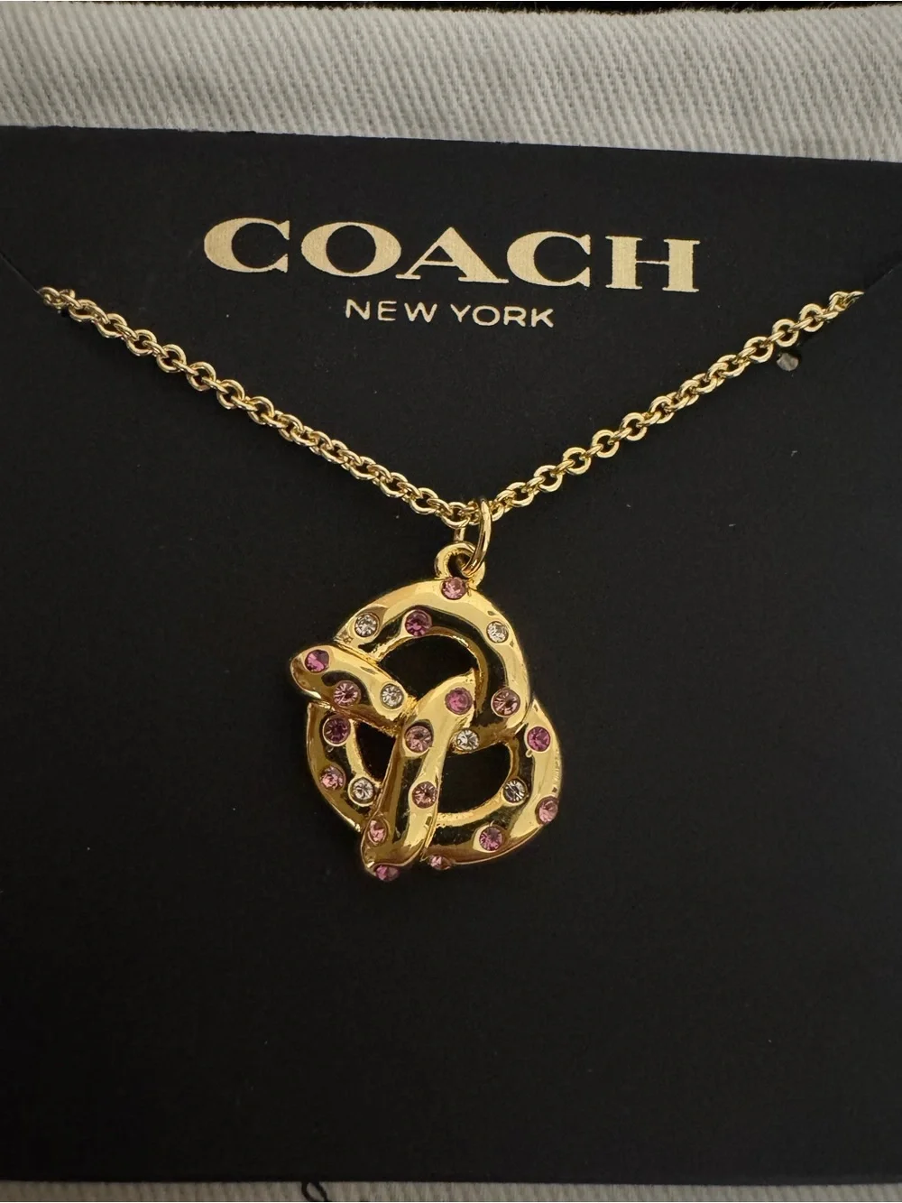 Coach Gold Pretzel Pendant Necklace with Pink Accents